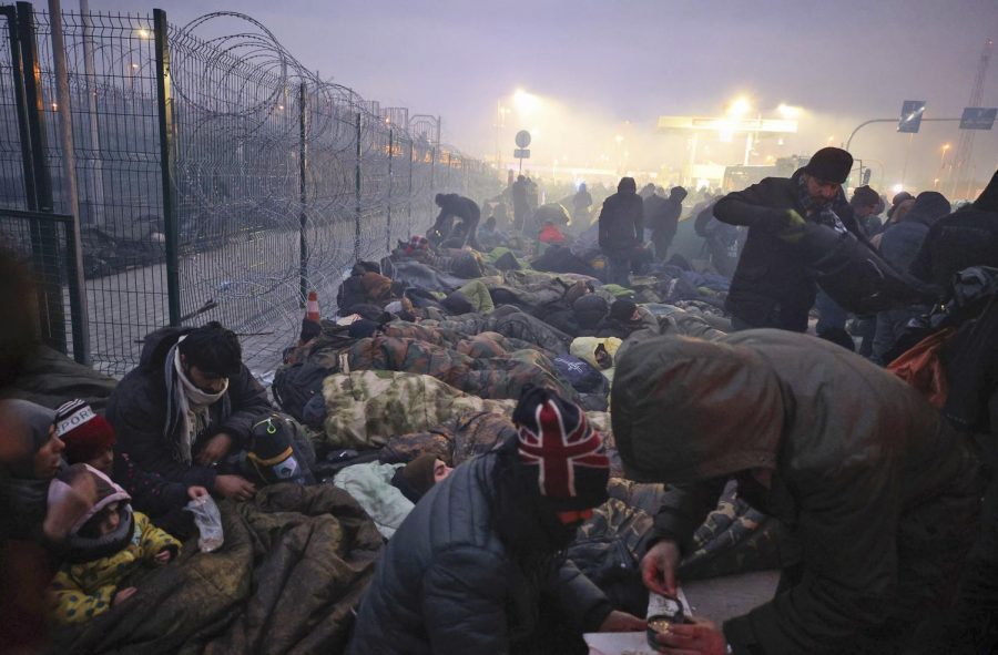 CRISIS AT THE BORDER: Migrants huddle for warmth at the "Kuznitsa" checkpoint at the Poland-Belarus border on Nov. 15.